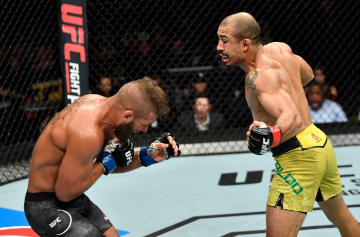 CALGARY, AB - JULY 28: (R-L) Jose Aldo of Brazil drops Jeremy Stephens with a punch to the body in their featherweight bout during the UFC Fight Night event at Scotiabank Saddledome on July 28, 2018 in Calgary, Alberta, Canada. (Photo by Jeff Bottari/Zuffa LLC via Getty Images)