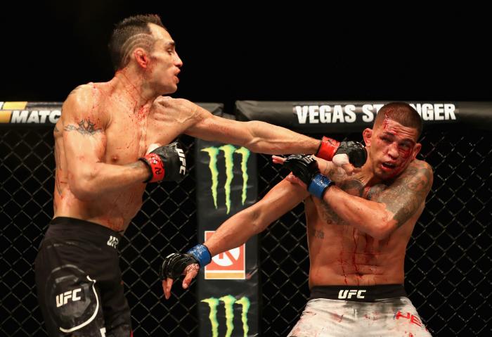 Tony Ferguson punches Anthony Pettis in their lightweight bout during the UFC 229 event inside T-Mobile Arena on October 6, 2018 in Las Vegas, Nevada.