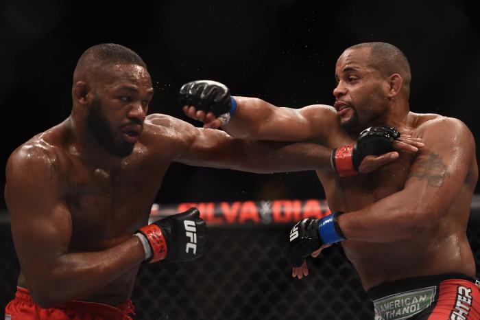 Jon Jones punches Daniel Cormier in their UFC light heavyweight championship bout during the UFC 182 event at the MGM Grand Garden Arena on January 3, 2015 in Las Vegas, Nevada.