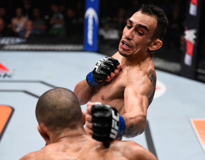 Tony Ferguson punches Edson Barboza in their lightweight bout during the TUF Finale event inside The Chelsea at The Cosmopolitan of Las Vegas on December 11, 2015 in Las Vegas, Nevada.