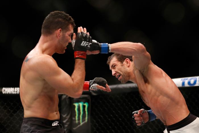 LAS VEGAS, NV - DECEMBER 12: (R-L) Luke Rockhold punches Chris Weidman in their UFC middleweight championship bout during the UFC 194 event inside MGM Grand Garden Arena on December 12, 2015 in Las Vegas, Nevada. (Photo by Christian Petersen/Zuffa LLC/Zuffa LLC via Getty Images)