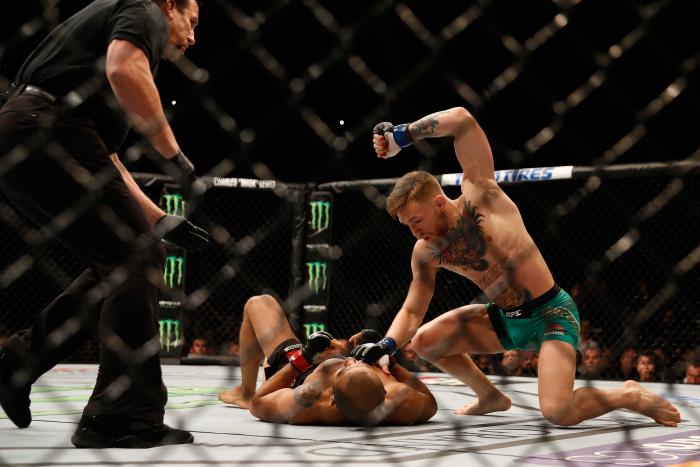 LAS VEGAS, NV - DECEMBER 12: Conor McGregor of Ireland (top) punches Jose Aldo of Brazil in their UFC featherweight championship bout during the UFC 194 event inside MGM Grand Garden Arena on December 12, 2015 in Las Vegas, Nevada. (Photo by Christian Petersen/Zuffa LLC/Zuffa LLC via Getty Images)