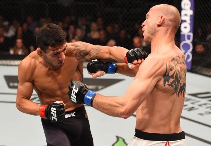 ORLANDO, FL - DECEMBER 19: (L-R) Rafael dos Anjos punches Donald Cerrone in their UFC lightweight title bout during the UFC Fight Night event at the Amway Center on December 19, 2015 in Orlando, Florida. (Photo by Josh Hedges/Zuffa LLC/Zuffa LLC via Getty Images)