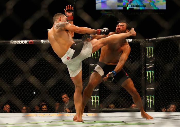 Robbert Whittaker kicks Rafael Natal in their middleweight bout during the UFC 197 event inside MGM Grand Garden Arena on April 23, 2016 in Las Vegas, Nevada.