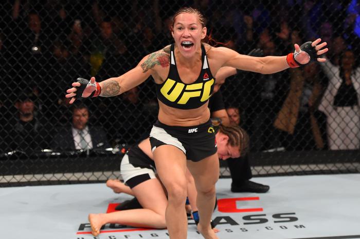 CURITIBA, BRAZIL - MAY 14: (L-R) Cristiane 'Cyborg' Justino of Brazil celebrates after defeating Leslie Smith in their women's catchweight bout during the UFC 198 event at Arena da Baixada stadium on May 14, 2016 in Curitiba, Parana, Brazil. (Photo by Josh Hedges/Zuffa LLC via Getty Images)