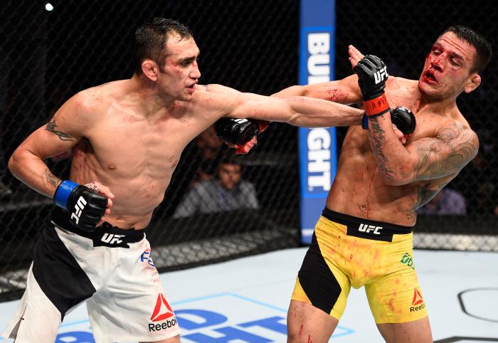 MEXICO CITY, MEXICO - NOVEMBER 05: (L-R) Tony Ferguson of the United States punches Rafael Dos Anjos of Brazil in their lightweight bout during the UFC Fight Night event at Arena Ciudad de Mexico on November 5, 2016 in Mexico City, Mexico. (Photo by Jeff Bottari/Zuffa LLC via Getty Images)