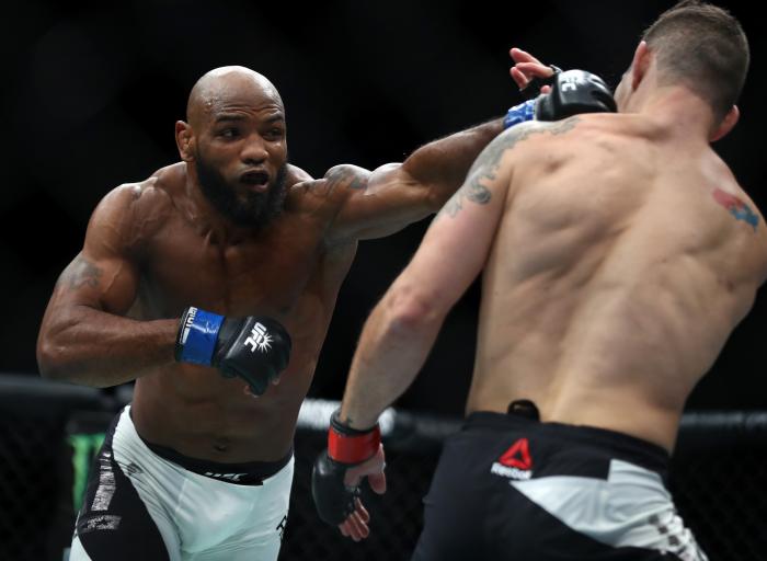 Yoel Romero punches Chris Weidman in their middleweight bout during the UFC 205 event at Madison Square Garden on November 12, 2016 in New York City.