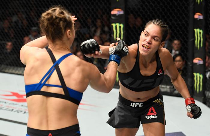 Amanda Nunes throws a punch at Ronda Rousey in their UFC women's bantamweight championship bout during the UFC 207 event at T-Mobile Arena on December 30, 2016 in Las Vegas, Nevada.