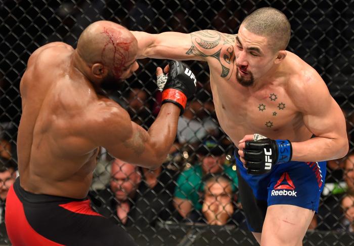 Robert Whittaker punches Yoel Romero in their interim UFC middleweight championship bout during the UFC 213 event at T-Mobile Arena on July 8, 2017 in Las Vegas, Nevada.