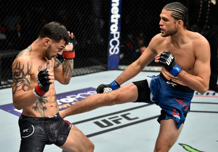 FRESNO, CA - DECEMBER 09: (R-L) Brian Ortega kicks in their featherweight bout during the UFC Fight Night event inside Save Mart Center on December 9, 2017 in Fresno, California. (Photo by Jeff Bottari/Zuffa LLC via Getty Images)