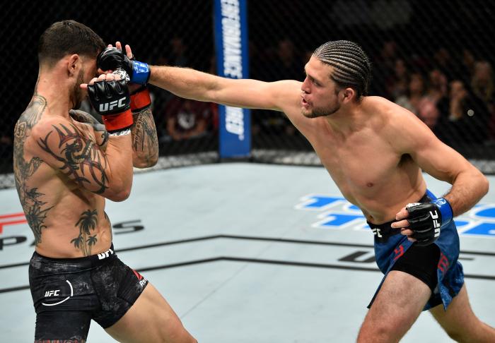 FRESNO, CA - DECEMBER 09: (R-L) Brian Ortega punches Cub Swanson in their featherweight bout during the UFC Fight Night event inside Save Mart Center on December 9, 2017 in Fresno, California. (Photo by Jeff Bottari/Zuffa LLC via Getty Images)