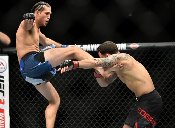 LAS VEGAS, NV - MARCH 03: (L-R) Brian Ortega kicks Frankie Edgar in their featherweight bout during the UFC 222 event inside T-Mobile Arena on March 3, 2018 in Las Vegas, Nevada. (Photo by Brandon Magnus/Zuffa LLC via Getty Images)