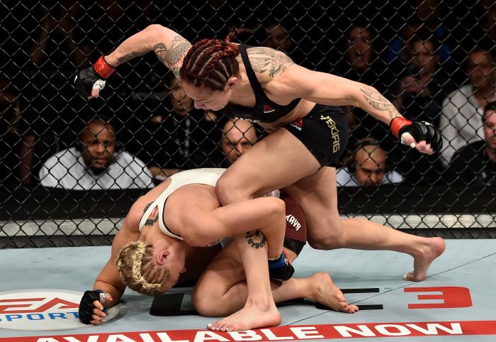 LAS VEGAS, NV - MARCH 03: (R-L) Cris Cyborg of Brazil punches Yana Kunitskaya of Russia in their women's featherweight bout during the UFC 222 event inside T-Mobile Arena on March 3, 2018 in Las Vegas, Nevada. (Photo by Jeff Bottari/Zuffa LLC via Getty Images)