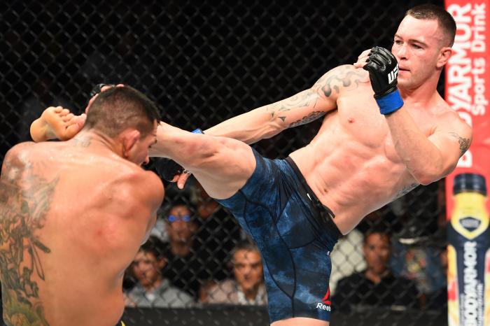 CHICAGO, ILLINOIS - JUNE 09: (R-L) Colby Covington kicks the head of Rafael Dos Anjos of Brazil in their interim welterweight title fight during the UFC 225 event at the United Center on June 9, 2018 in Chicago, Illinois. (Photo by Josh Hedges/Zuffa LLC via Getty Images)