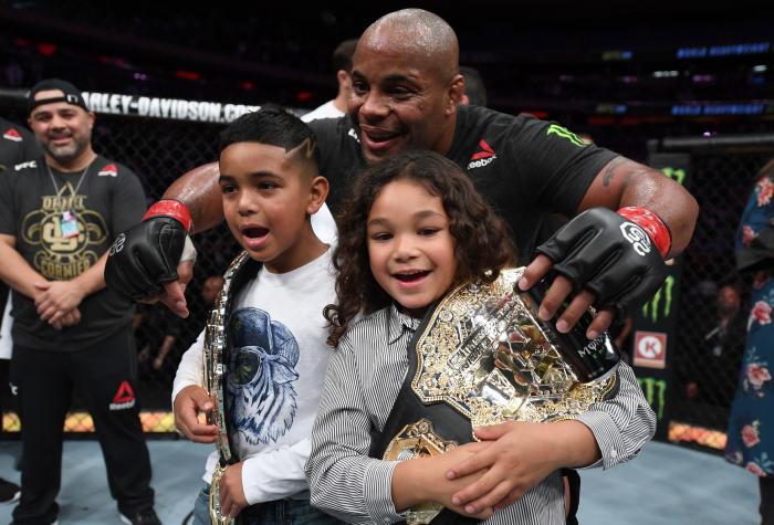 NEW YORK, NY - NOVEMBER 03: Daniel Cormier celebrates with his kids after his submission victory over Derrick Lewis in their UFC heavyweight championship bout during the UFC 230 event inside Madison Square Garden on November 3, 2018 in New York, New York. (Photo by Jeff Bottari/Zuffa LLC via Getty Images)