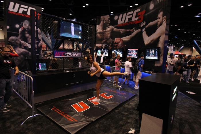 A trainer demonstrates the UFC Personal Trainer videogame
