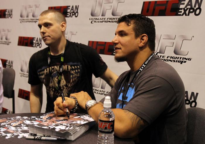 Frank Mir signs autographs for a fan