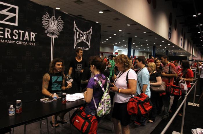 UFC Fighter Clay Guida signs autographs for fans