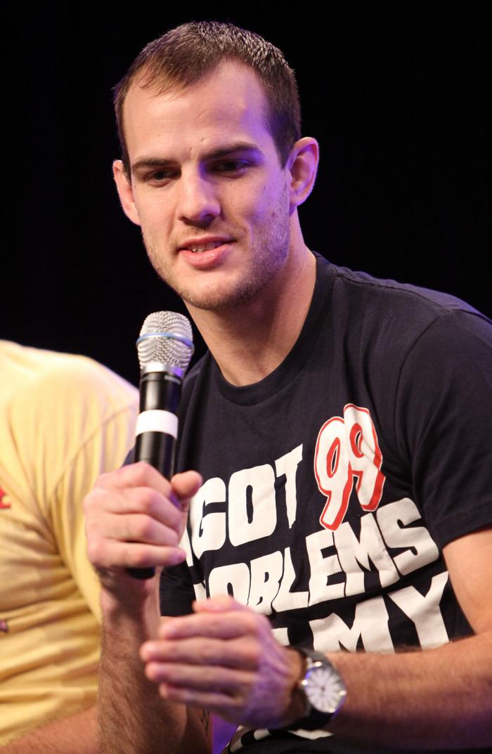 UFC fighter Cole Miller attends a Q&A session with former cast members of The Ultimate Fighter on the main stage at the UFC Fan Expo