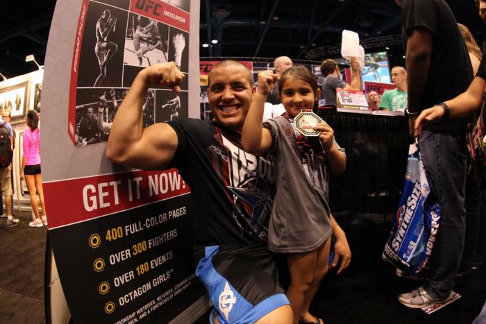 UFC fighter Pat Barry poses for a photo with a young fan at the UFC Fan Expo