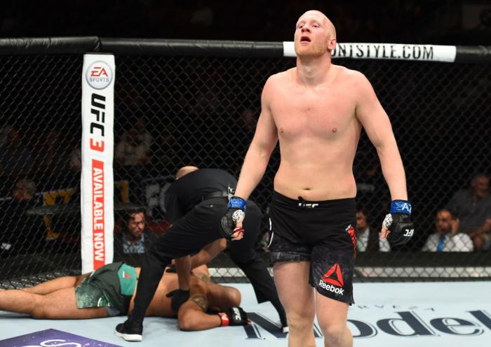 GLENDALE, AZ - APRIL 14: (R-L) Adam Wieczorek of Poland celebrates his victory over Arjan Singh Bhullar of Canada in their heavyweight fight during the UFC Fight Night event at the Gila Rivera Arena on April 14, 2018 in Glendale, Arizona. (Photo by Josh
