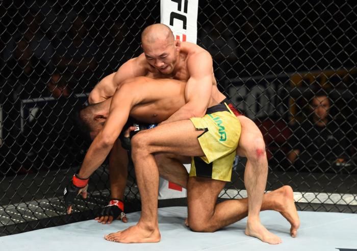 GLENDALE, AZ - APRIL 14: (R-L) Yushin Okami of Japan controls the body of Dhiego Lima of Brazil in their welterweight fight during the UFC Fight Night event at the Gila Rivera Arena on April 14, 2018 in Glendale, Arizona. (Photo by Josh Hedges/Zuffa LLC/