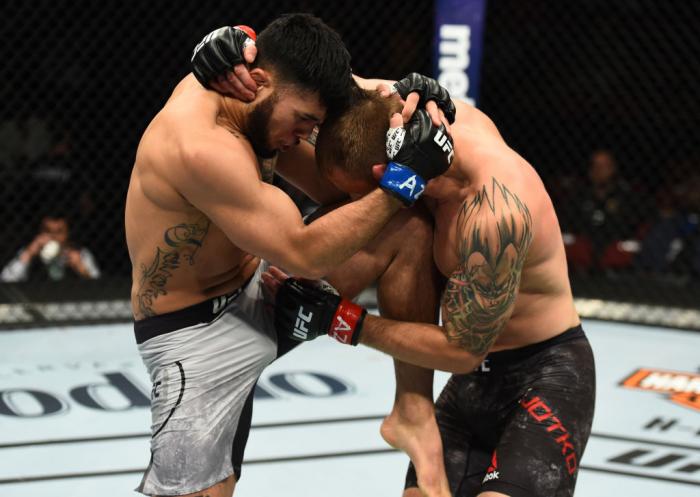 GLENDALE, AZ - APRIL 14: (L-R) Brad Tavares knees Krzysztof Jotko of Poland in their middleweight fight during the UFC Fight Night event at the Gila Rivera Arena on April 14, 2018 in Glendale, Arizona. (Photo by Josh Hedges/Zuffa LLC/Zuffa LLC via Getty