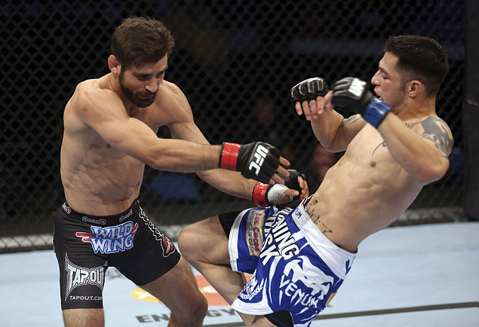 CALGARY, CANADA - JULY 21: (L-R) Antonio Carvalho exchanges punches with Daniel Pineda during their featherweight bout at UFC 149 inside the Scotiabank Saddledome on July 21, 2012 in Calgary, Alberta, Canada. (Photo by Nick Laham/Zuffa LLC/Zuffa LLC via