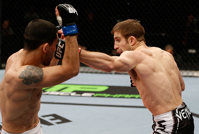LONDON, ENGLAND - FEBRUARY 16: (R-L) Phil Harris punches Ulysses Gomez in their flyweight fight during the UFC on Fuel TV event on February 16, 2013 at Wembley Arena in London, England. (Photo by Josh Hedges/Zuffa LLC/Zuffa LLC via Getty Images)