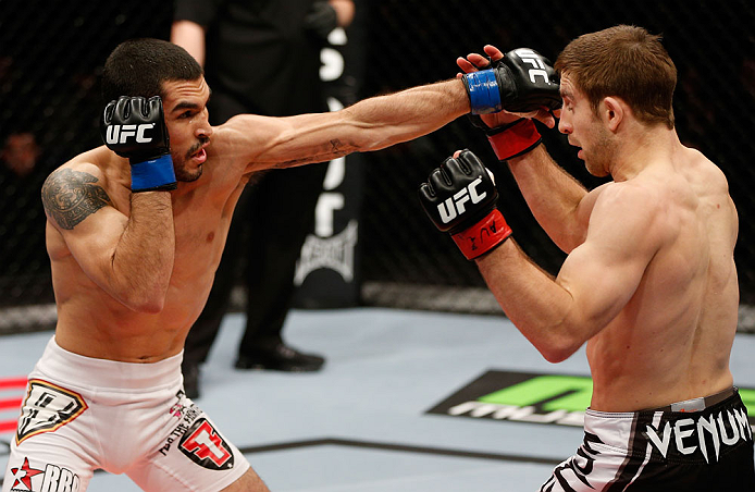 LONDON, ENGLAND - FEBRUARY 16: (L-R) Ulysses Gomez punches Phil Harris in their flyweight fight during the UFC on Fuel TV event on February 16, 2013 at Wembley Arena in London, England. (Photo by Josh Hedges/Zuffa LLC/Zuffa LLC via Getty Images)