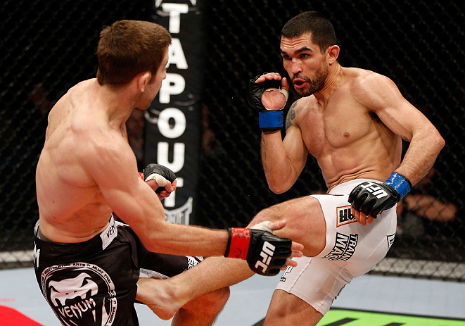 LONDON, ENGLAND - FEBRUARY 16: (R-L) Ulysses Gomez kicks Phil Harris in their flyweight fight during the UFC on Fuel TV event on February 16, 2013 at Wembley Arena in London, England. (Photo by Josh Hedges/Zuffa LLC/Zuffa LLC via Getty Images)