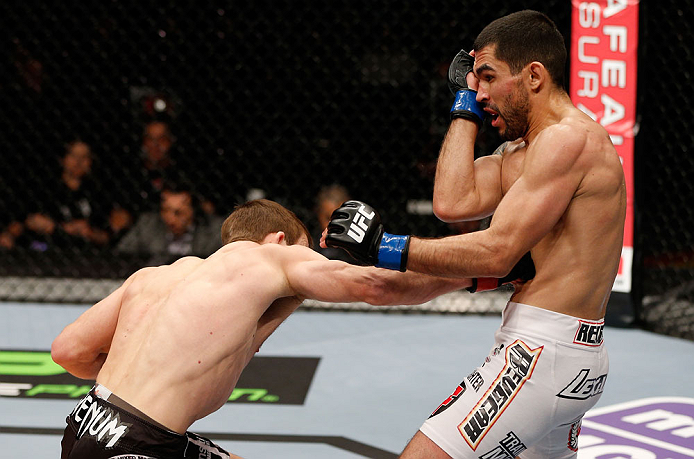 LONDON, ENGLAND - FEBRUARY 16: (L-R) Phil Harris punches Ulysses Gomez in their flyweight fight during the UFC on Fuel TV event on February 16, 2013 at Wembley Arena in London, England. (Photo by Josh Hedges/Zuffa LLC/Zuffa LLC via Getty Images)