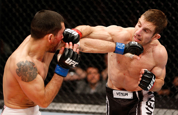 LONDON, ENGLAND - FEBRUARY 16: (R-L) Phil Harris punches Ulysses Gomez in their flyweight fight during the UFC on Fuel TV event on February 16, 2013 at Wembley Arena in London, England. (Photo by Josh Hedges/Zuffa LLC/Zuffa LLC via Getty Images)