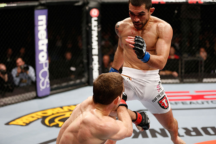 LONDON, ENGLAND - FEBRUARY 16: (R-L) Ulysses Gomez delivers a flying knee against Phil Harris in their flyweight fight during the UFC on Fuel TV event on February 16, 2013 at Wembley Arena in London, England. (Photo by Josh Hedges/Zuffa LLC/Zuffa LLC vi
