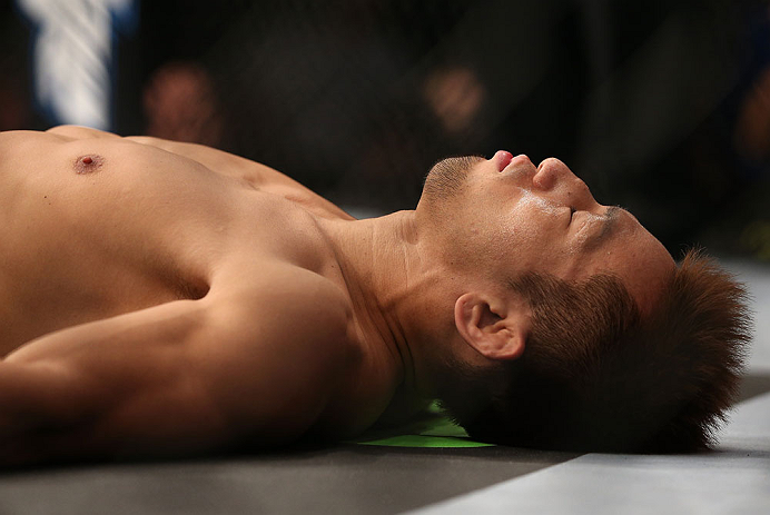 DENVER, CO - AUGUST 11: Eiji Mitsuoka lies on the canvas before his bout against Nik Lentz at UFC 150 inside Pepsi Center on August 11, 2012 in Denver, Colorado. (Photo by Josh Hedges/Zuffa LLC/Zuffa LLC via Getty Images)