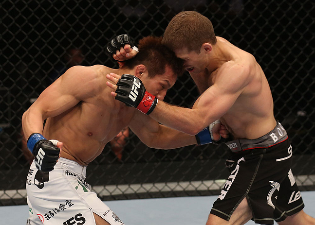 DENVER, CO - AUGUST 11: (L-R) Eiji Mitsuoka punches to the body of Nik Lentz during their featherweight bout at UFC 150 inside Pepsi Center on August 11, 2012 in Denver, Colorado. (Photo by Nick Laham/Zuffa LLC/Zuffa LLC via Getty Images)