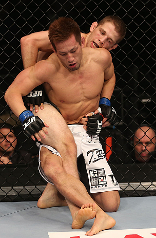 DENVER, CO - AUGUST 11: (R-L) Nik Lentz and Eiji Mitsuoka grapple during their featherweight bout at UFC 150 inside Pepsi Center on August 11, 2012 in Denver, Colorado. (Photo by Nick Laham/Zuffa LLC/Zuffa LLC via Getty Images)