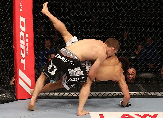 DENVER, CO - AUGUST 11: (L-R) Nik Lentz takes down Eiji Mitsuoka during their featherweight bout at UFC 150 inside Pepsi Center on August 11, 2012 in Denver, Colorado. (Photo by Nick Laham/Zuffa LLC/Zuffa LLC via Getty Images)