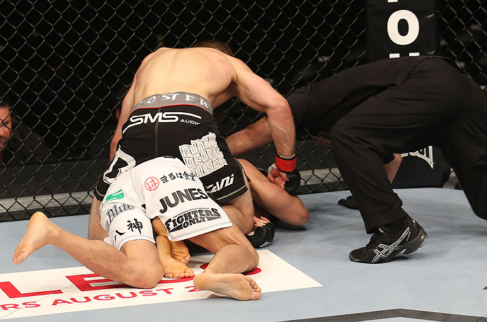 DENVER, CO - AUGUST 11: Nik Lentz (black shorts) punches down at Eiji Mitsuoka during their featherweight bout at UFC 150 inside Pepsi Center on August 11, 2012 in Denver, Colorado. (Photo by Nick Laham/Zuffa LLC/Zuffa LLC via Getty Images)