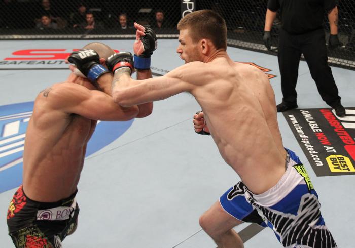 OMAHA, NE - FEBRUARY 15: (R-L) Tim Means punches Bernardo Magalhaes during the UFC on FUEL TV event at Omaha Civic Auditorium on February 15, 2012 in Omaha, Nebraska. (Photo by Josh Hedges/Zuffa LLC/Zuffa LLC via Getty Images) *** Local Caption *** Tim
