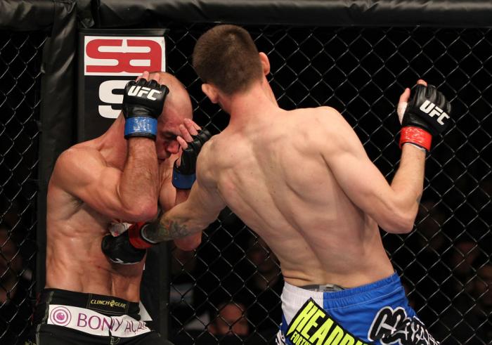 OMAHA, NE - FEBRUARY 15: (R-L) Tim Means punches Bernardo Magalhaes during the UFC on FUEL TV event at Omaha Civic Auditorium on February 15, 2012 in Omaha, Nebraska. (Photo by Josh Hedges/Zuffa LLC/Zuffa LLC via Getty Images) *** Local Caption *** Tim