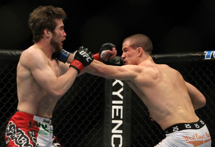TORONTO, ON - DECEMBER 10: (R-L) John Cholish punches Mitch Clarke during the UFC 140 event at Air Canada Centre on December 10, 2011 in Toronto, Ontario, Canada. (Photo by Josh Hedges/Zuffa LLC/Zuffa LLC via Getty Images)
