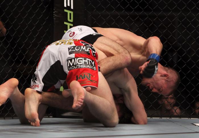 TORONTO, ON - DECEMBER 10: (R-L) John Cholish punches Mitch Clarke during the UFC 140 event at Air Canada Centre on December 10, 2011 in Toronto, Ontario, Canada. (Photo by Josh Hedges/Zuffa LLC/Zuffa LLC via Getty Images)