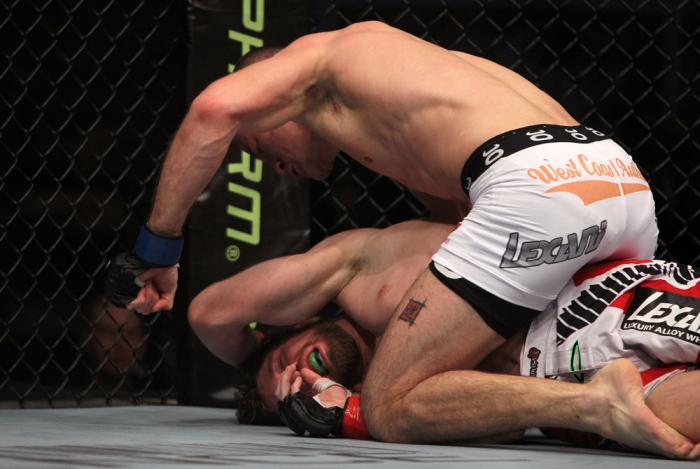 TORONTO, ON - DECEMBER 10: (R-L) John Cholish punches Mitch Clarke during the UFC 140 event at Air Canada Centre on December 10, 2011 in Toronto, Ontario, Canada. (Photo by Josh Hedges/Zuffa LLC/Zuffa LLC via Getty Images)