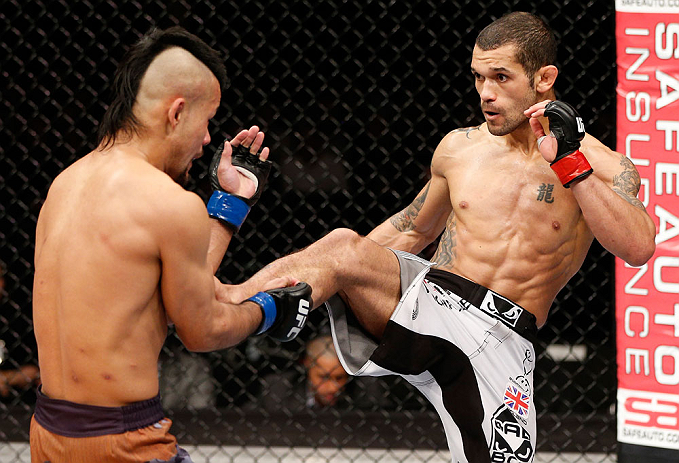 LONDON, ENGLAND - FEBRUARY 16: (R-L) Vaughan Lee kicks Motonobu Tezuka in their bantamweight fight during the UFC on Fuel TV event on February 16, 2013 at Wembley Arena in London, England. (Photo by Josh Hedges/Zuffa LLC/Zuffa LLC via Getty Images)