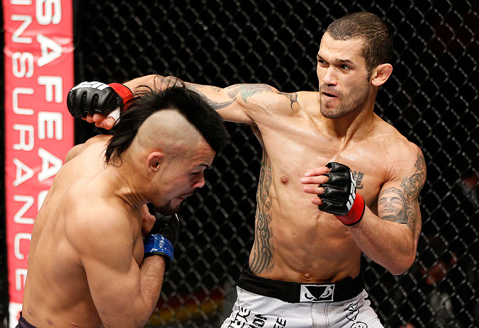 LONDON, ENGLAND - FEBRUARY 16: (R-L) Vaughan Lee punches Motonobu Tezuka in their bantamweight fight during the UFC on Fuel TV event on February 16, 2013 at Wembley Arena in London, England. (Photo by Josh Hedges/Zuffa LLC/Zuffa LLC via Getty Images)