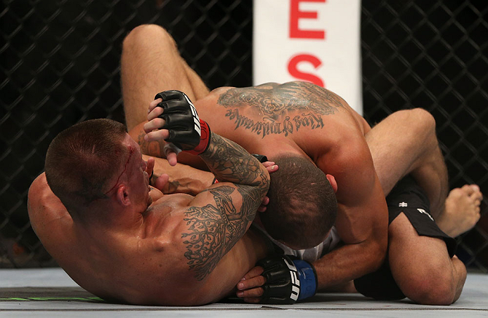DENVER, CO - AUGUST 11: (L-R) Dustin Pague delivers an elbow strike against Chico Camus on the ground during their bantamweight bout at UFC 150 inside Pepsi Center on August 11, 2012 in Denver, Colorado. (Photo by Josh Hedges/Zuffa LLC/Zuffa LLC via Gett