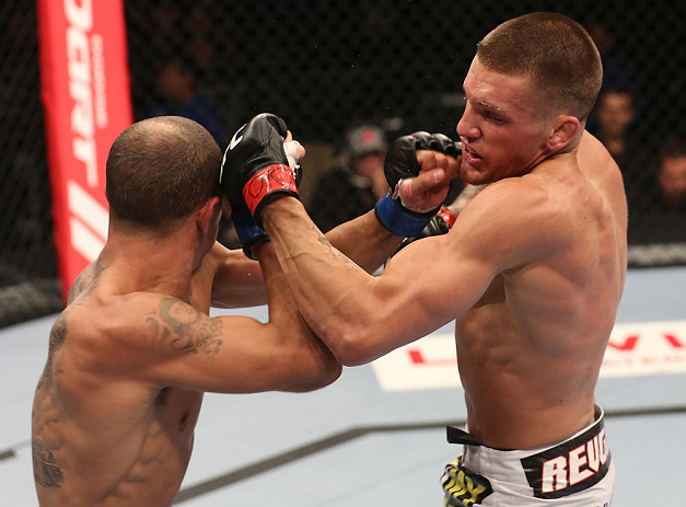 DENVER, CO - AUGUST 11: (R-L) Dustin Pague punches Chico Camus during their bantamweight bout at UFC 150 inside Pepsi Center on August 11, 2012 in Denver, Colorado. (Photo by Nick Laham/Zuffa LLC/Zuffa LLC via Getty Images)