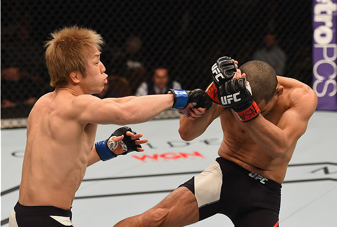 LAS VEGAS, NV - JANUARY 02: (L-R) Michinori Tanaka of Japan punches Joe Soto in their bantamweight bout during the UFC 195 event inside MGM Grand Garden Arena on January 2, 2016 in Las Vegas, Nevada. (Photo by Josh Hedges/Zuffa LLC/Zuffa LLC via Getty Im