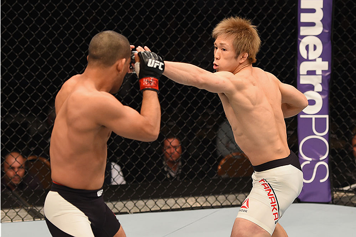 LAS VEGAS, NV - JANUARY 02: (R-L) Michinori Tanaka of Japan punches Joe Soto in their bantamweight bout during the UFC 195 event inside MGM Grand Garden Arena on January 2, 2016 in Las Vegas, Nevada. (Photo by Josh Hedges/Zuffa LLC/Zuffa LLC via Getty Im